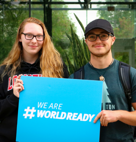Participants holding a world ready sign