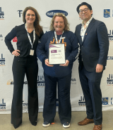 Laura Briscoe, Rosie Hessian Director of Jill of Trades, and Jeffrey Yao standing together with partnership agreement.